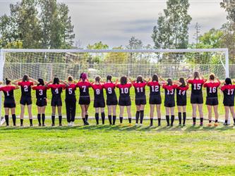 Girls soccer team players showing backs of their jerseys
