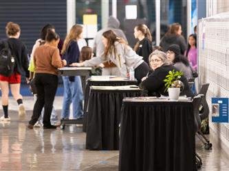 A hallway shot of the open house event with students and staff