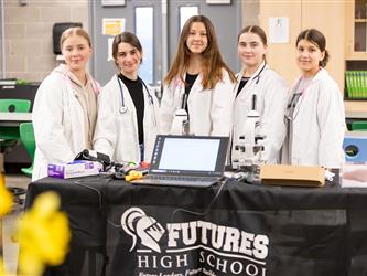 5 students are standing at their science display table