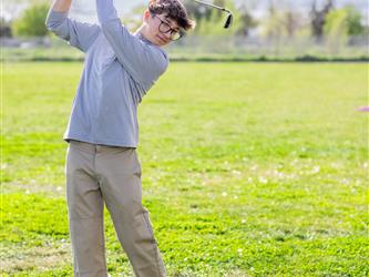 Golf player swinging ball