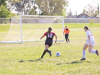 Soccer players in field