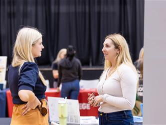 Students reviewing materials and speaking with recruiters