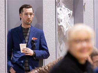 Man standing and listening to presentation