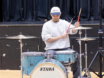 student throwing up peace sign 
