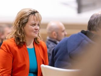 Woman holding papers smiling