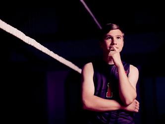 Volleyball player posing by net
