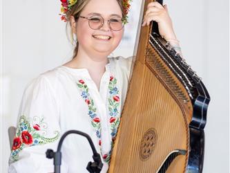 Student doing traditional dance in white dress