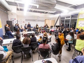 Students and teachers gathered in a classroom facing Futures admin staff
