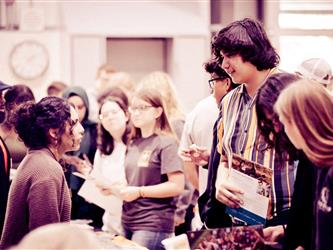 Students reviewing materials and speaking with recruiters
