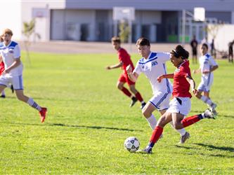 Student kicking ball