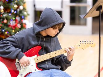kid playingf guitar