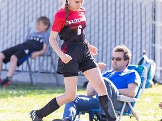 Soccer player on side line with ball