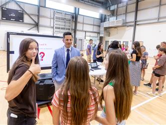 Students and families talking to teachers