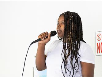 2 students speaking on stage