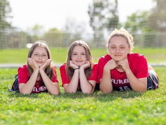 Girls soccer team players posing