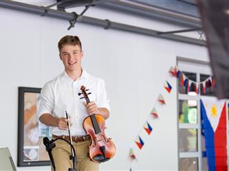 Student on stage playing violin