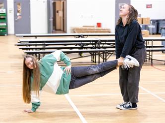 2 girls doing a wheelbarrel race