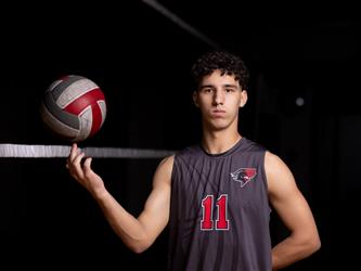 Volleyball player posing with ball
