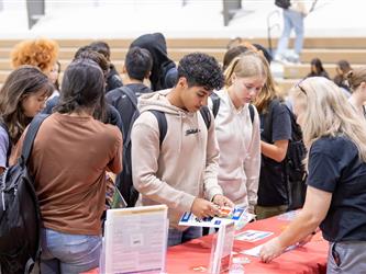 Students reviewing recruitment tables
