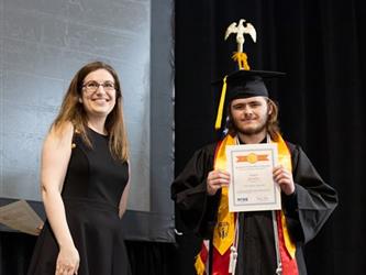 Student posing with certificate