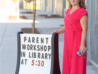 woman in front of welcome sign