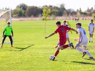 Student kicking ball towards goal