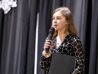 Student speaking into microphone
