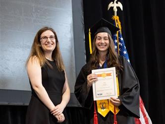 Student posing with certificate