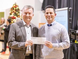 Two men presenting check