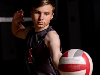 Volleyball player about to serve the ball
