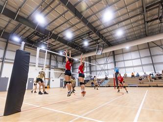 Futures Girls Volleyball team defending the net