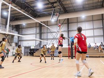 Futures Girls Volleyball team defending the net