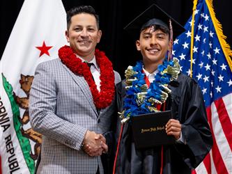 futures principal posing with graduating student