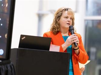 Presenter speaking into microphone