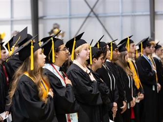 Grads saluting flag