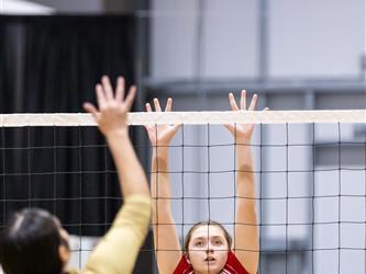 Futures Girls Volleyball team defending the net