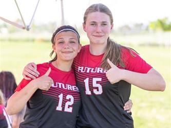 Two soccer players with thumbs up