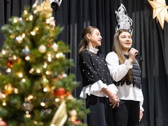 Two girls singing on stage