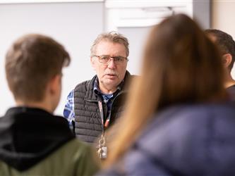 A staff member is engaging with guests