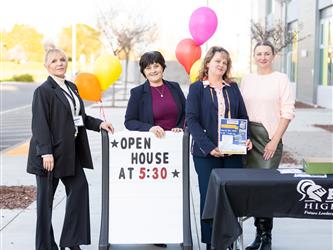 Futures staff are posed at the open house sign
