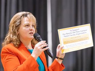 Woman speaking about information handout