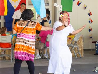 2 students doing traditional dance in cultural dresses