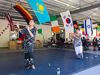 2 students doing traditional dance in cultural dresses