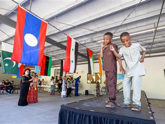 2 students on stage in cultural attire 